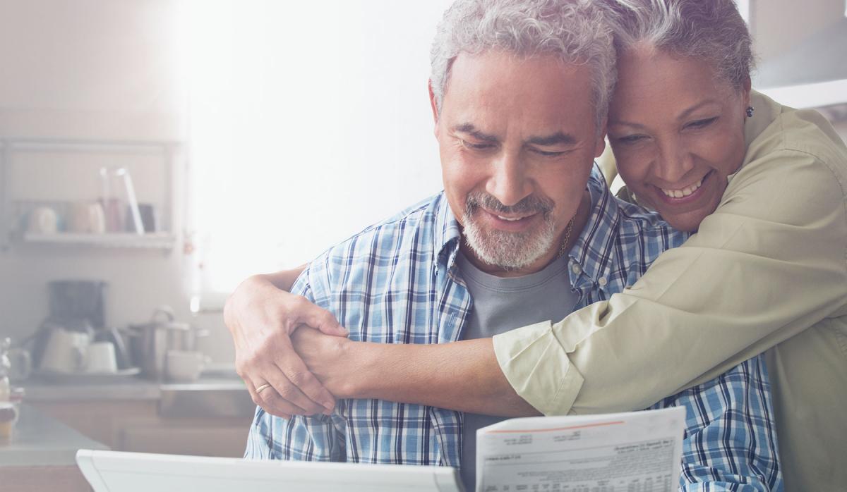 husband and wife looking at their refinance loan closing documents